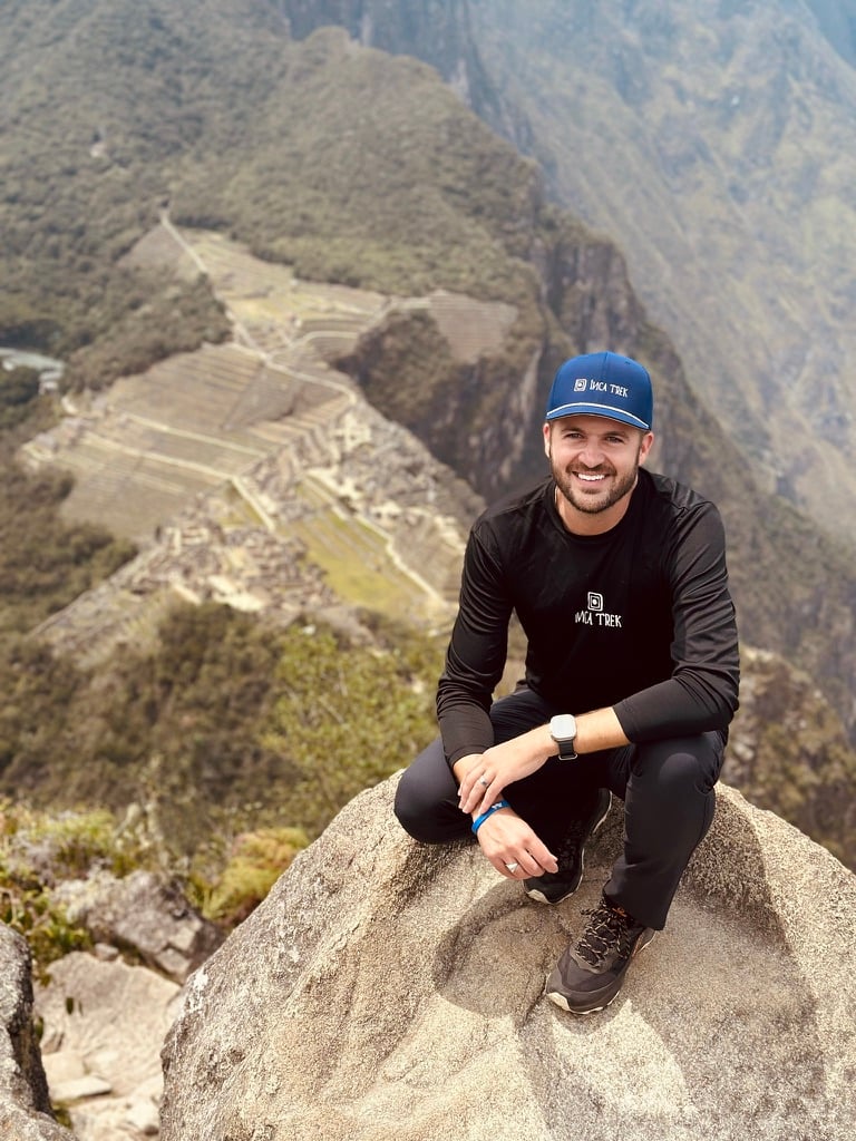 Jared Snow, founder of Inca Trek, on Huayna Picchu with Machu Picchu far below
